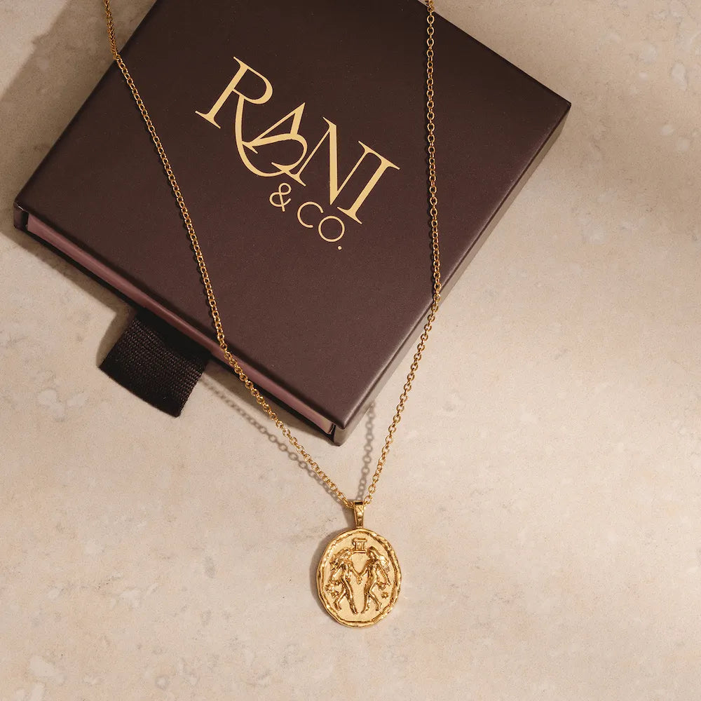 Gold Gemini zodiac pendant necklace with twin symbol and constellation stars astrology jewellery for Gemini sign