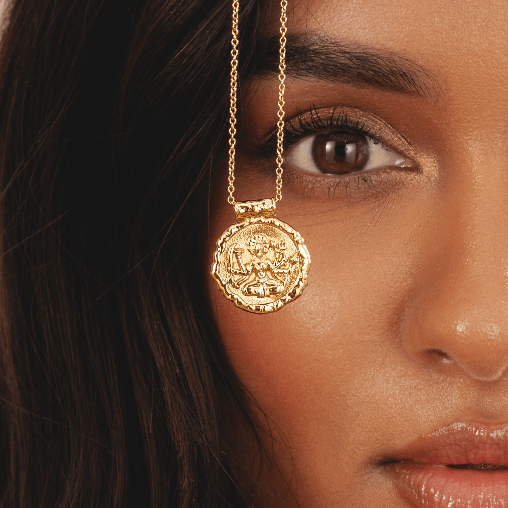 Gold pendant necklace featuring Hindu goddess Durga in 18k plated finish by Rani and Co womens jewellery