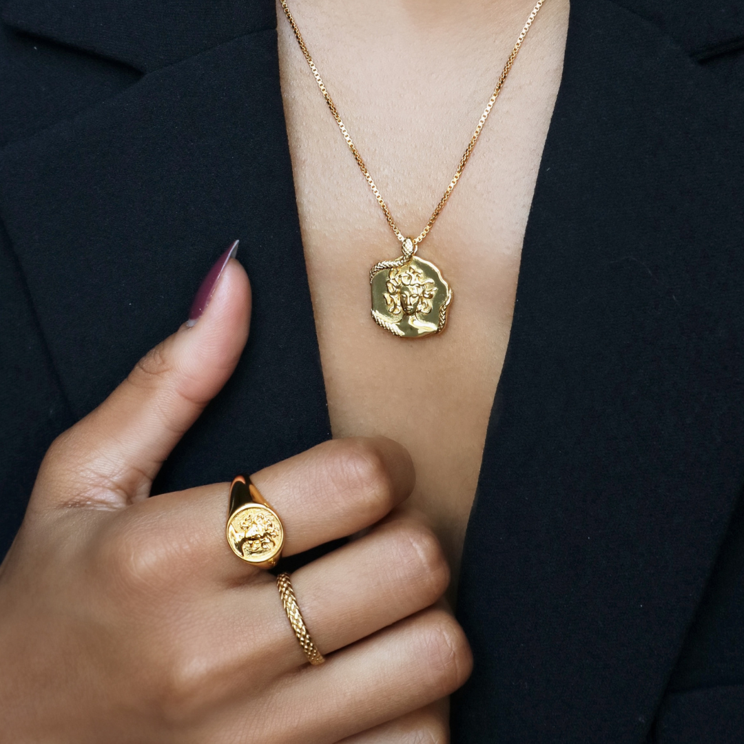 Gold signet ring for women featuring Medusa design in 18k plated finish by Rani and Co womens jewellery
