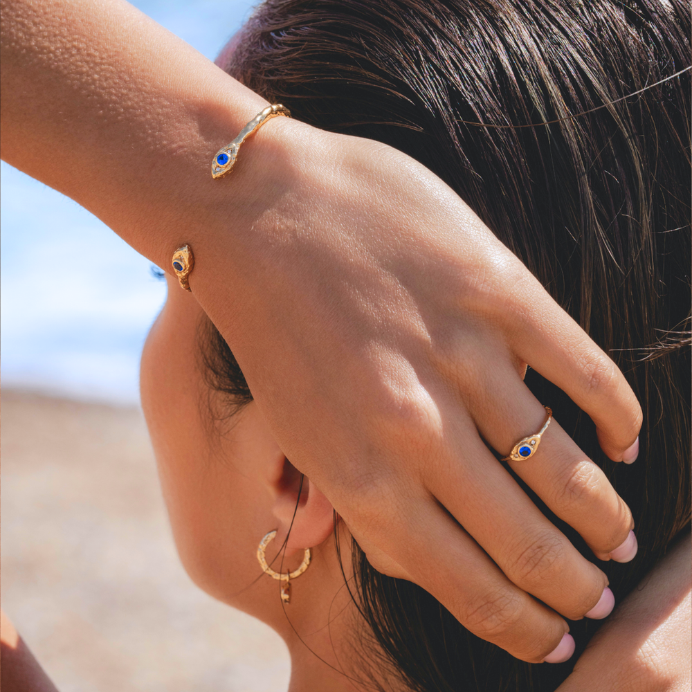 Gold cuff bracelet with evil eye jewellery and molten texture by Rani and Co womens jewellery