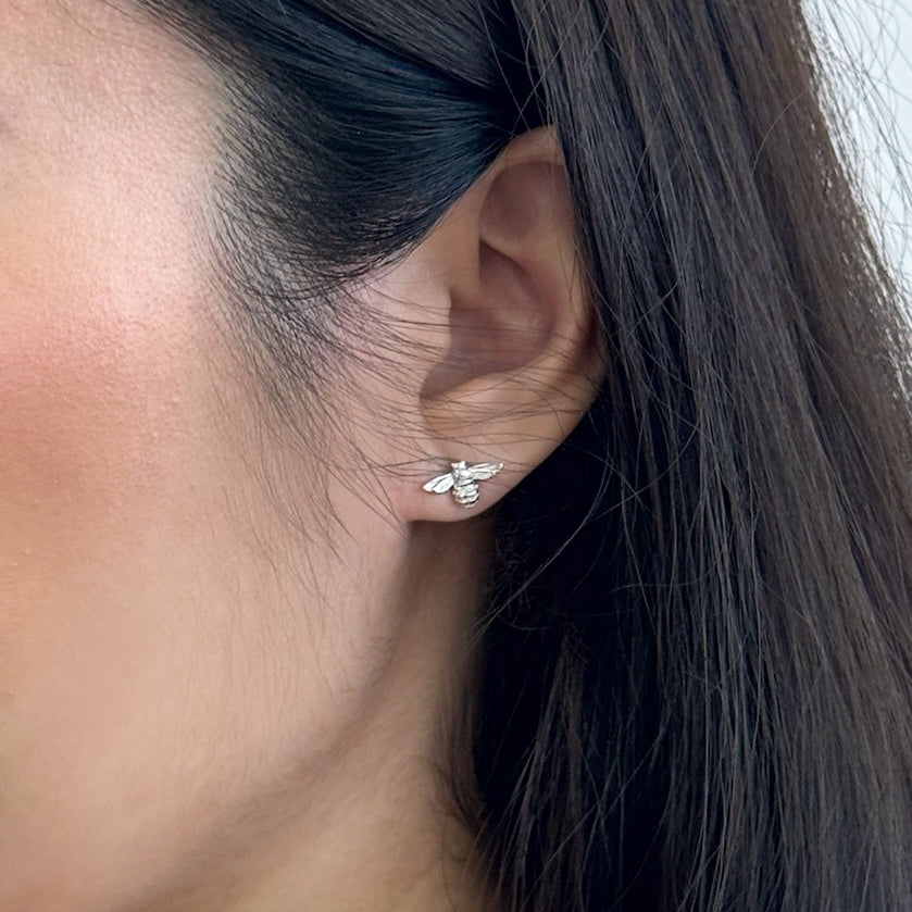 Silver stud earrings for women featuring delicate bumble bee studs in silver by Rani and Co