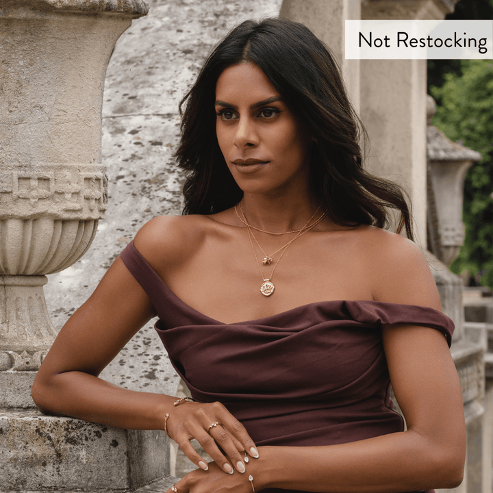 Limited Edition Goddess Durga Amethyst Necklace worn layered with gold jewellery and elegant occasion styling.