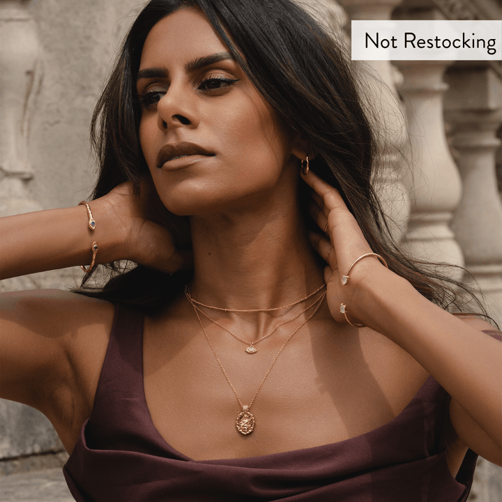 Limited Edition Goddess Saraswati Blue Topaz Necklace worn layered with gold jewellery for elegant everyday styling.