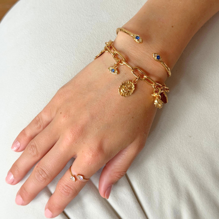 Gold chunky chain link bracelet styled as a charm bracelet by Rani and Co jewellery