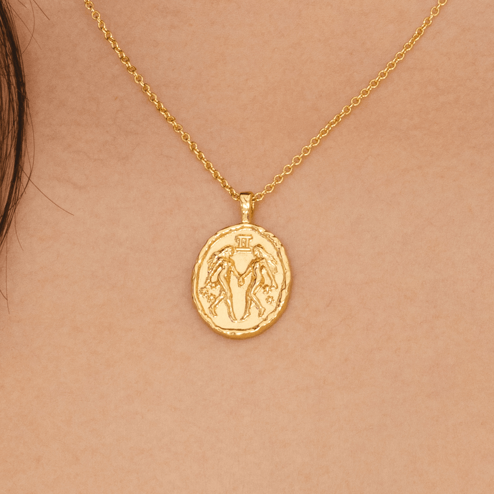 Gold Gemini zodiac coin pendant necklace with twin symbol and constellation stars astrology jewellery for Gemini horoscope