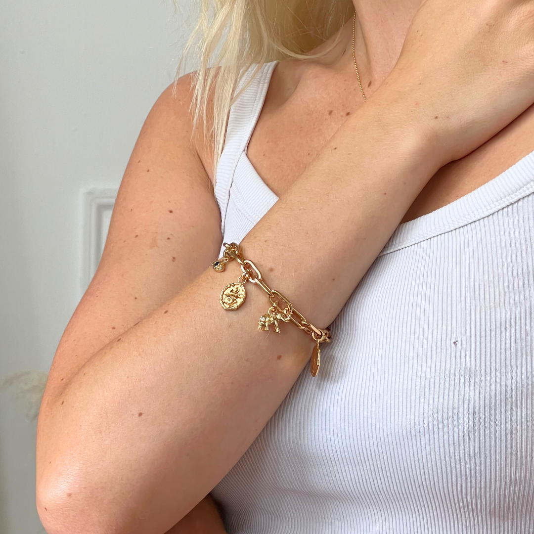 Gold chunky chain link bracelet styled as a charm bracelet by Rani and Co jewellery