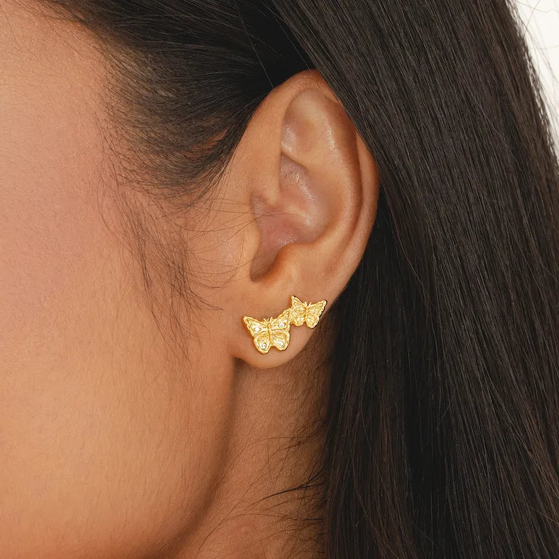 Ascending double butterfly gold earrings with CZ diamond accents, ethical recycled brass studs