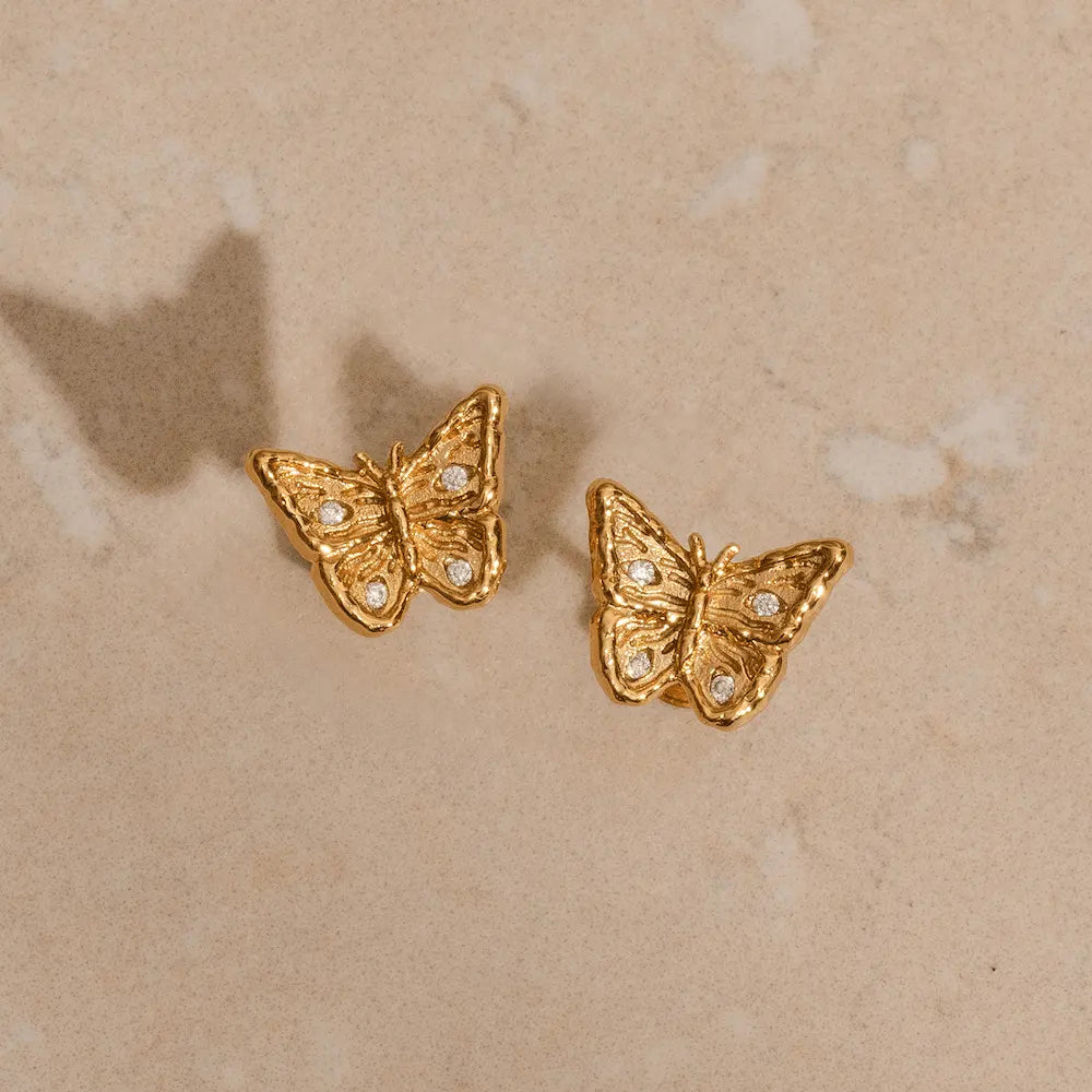 Small gold butterfly studs with filigree wings and CZ stones, sustainable recycled brass earrings
