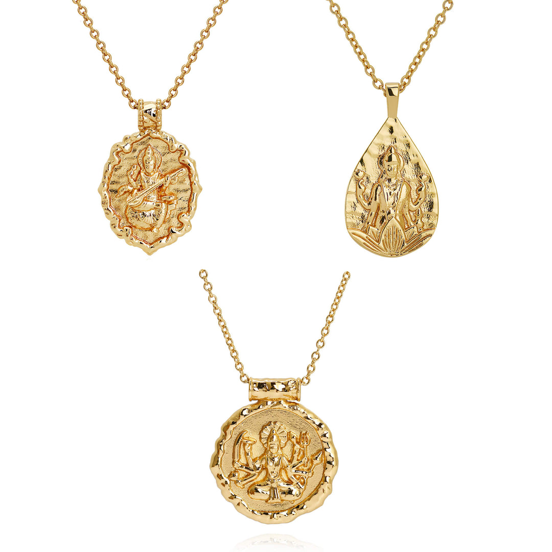Three gold hindu goddess pendant necklaces on chains, shown against a plain white background. Goddess Saraswati, Durga and Lakshmi