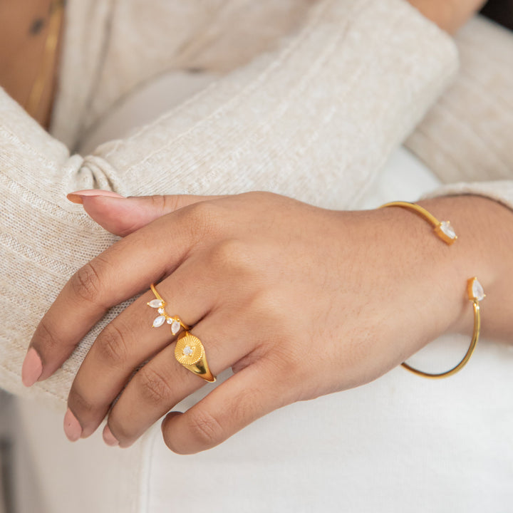 Elegant gold ring featuring three marquise-cut moonstones in a crown design.