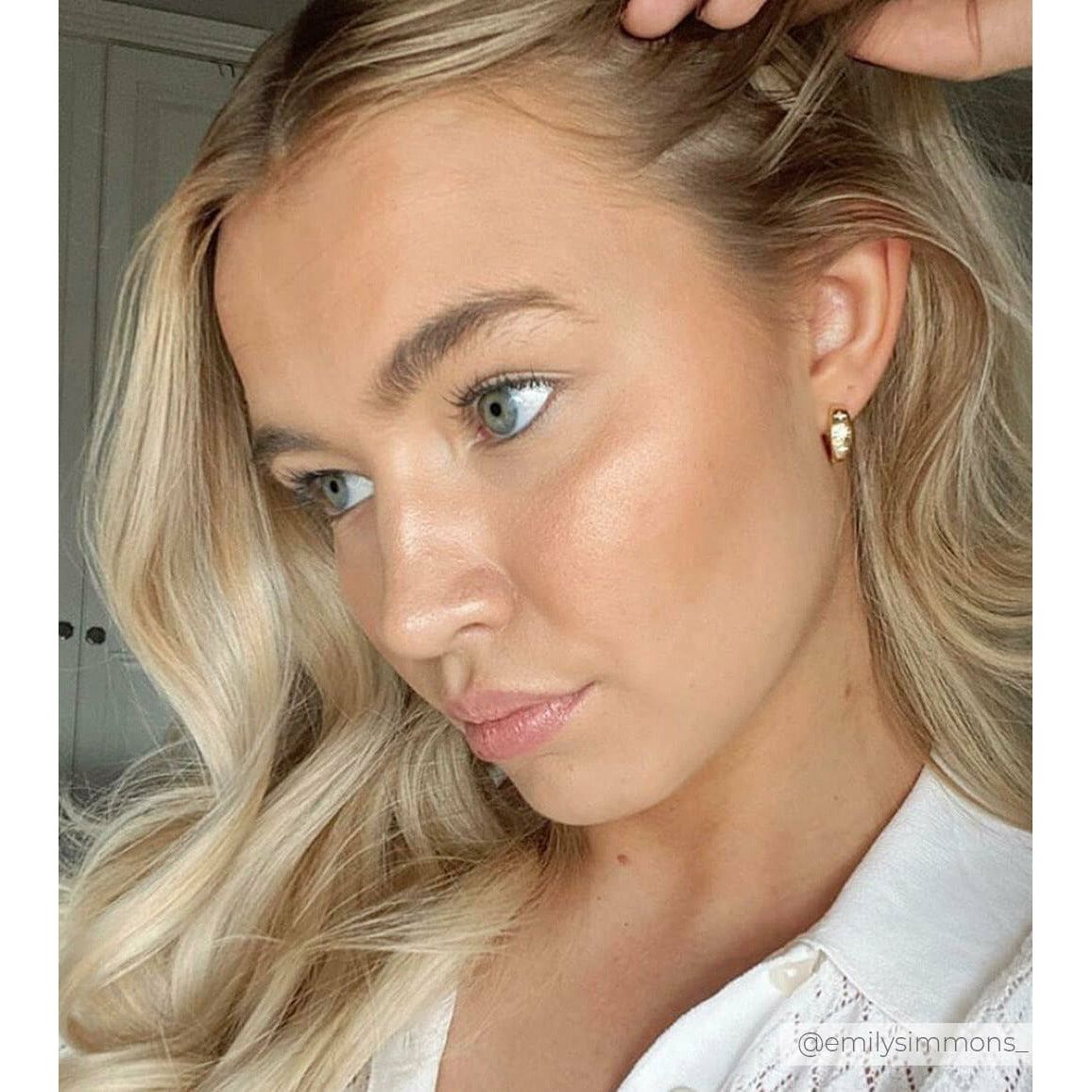 Influencer Emily Simmons wearing thick small gold hoops with 2 cubic zirconia stars-Rani & Co.
