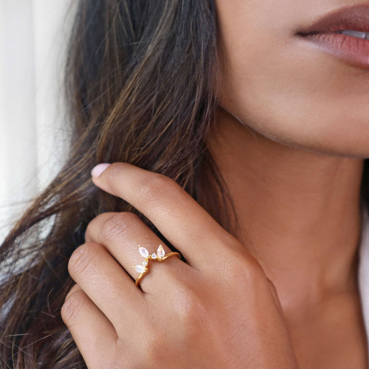 Crown-style gold ring with trio of marquise rainbow moonstones.
