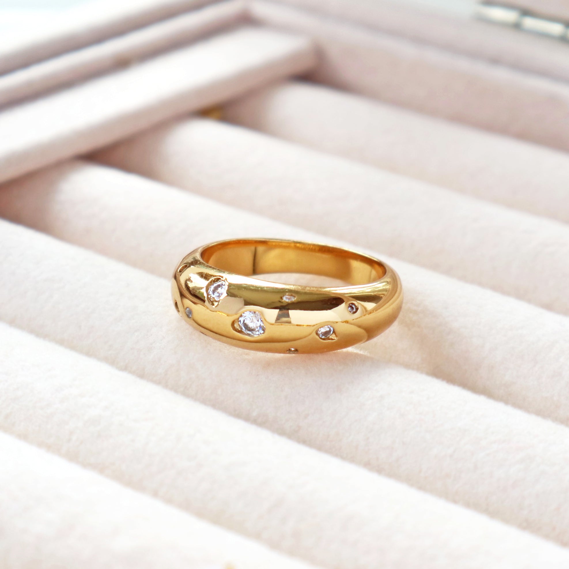 Womens jewellery by Rani and Co showcasing a bold gold ring with cubic zirconia in a dome design