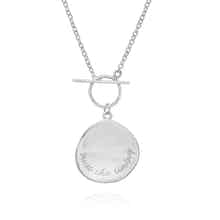 Engraved silver necklace featuring trust the timing message on a delicate disc pendant by Rani and Co